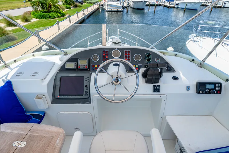 Slide: The Image of Helm of 2006 Beneteau Swift Trawler 42 with navigational instruments and steering wheel. - 56
