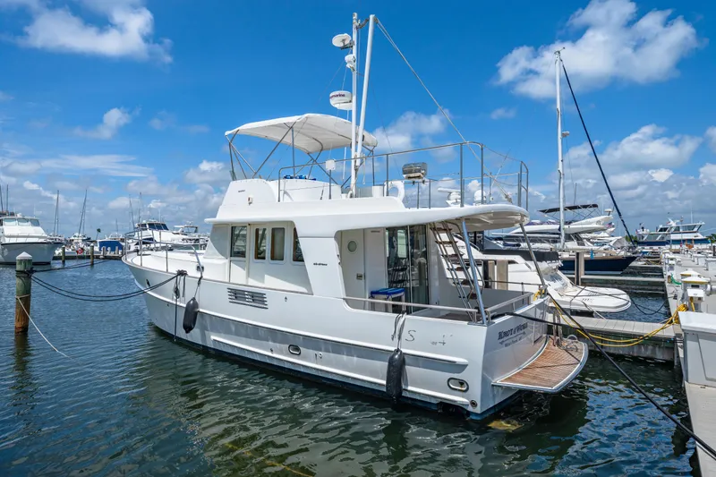 Slide: The Image of 2006 Beneteau Swift Trawler 42 docked at marina under blue sky. - 28