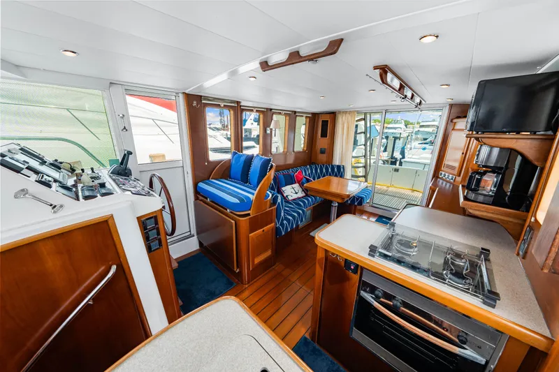 Slide: The Image of Interior of 2006 Beneteau Swift Trawler 42, featuring cozy seating and modern kitchen amenities. - 68