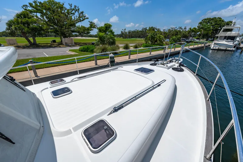 Slide: The Image of 2006 Beneteau Swift Trawler 42 docked, showcasing spacious deck and scenic marina view. - 42