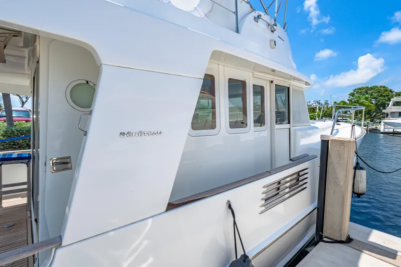 Slide: The Image of 2006 Beneteau Swift Trawler 42 docked, showcasing sleek white exterior and modern design. - 35