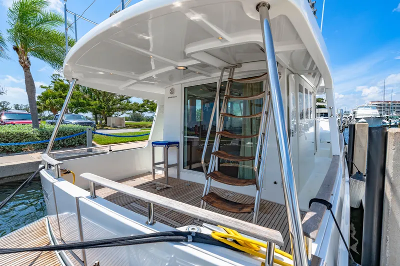Slide: The Image of 2006 Beneteau Swift Trawler 42 docked, featuring spacious deck and elegant design. - 33