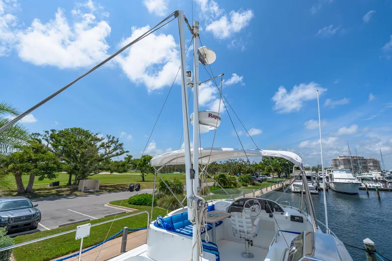 Slide: The Image of 2006 Beneteau Swift Trawler 42 docked at marina under clear blue sky. - 52