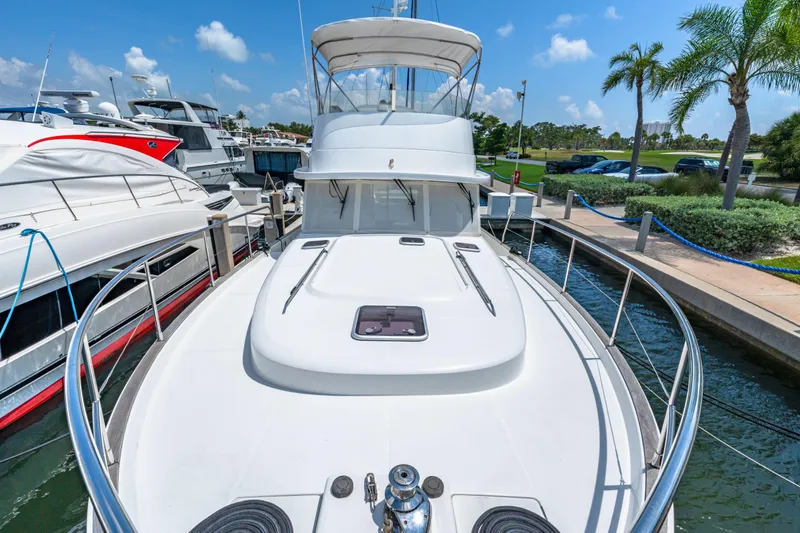 Slide: The Image of 2006 Beneteau Swift Trawler 42 docked, showcasing sleek design and spacious deck. - 44