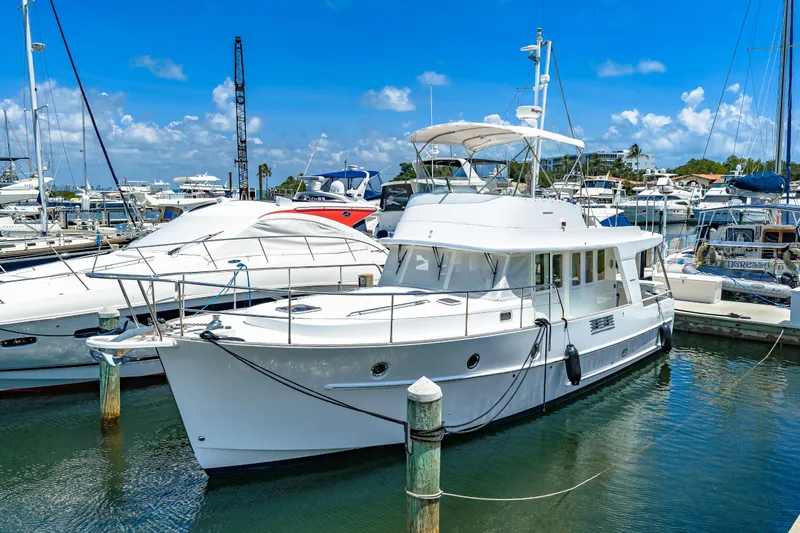 The Image of 2006 Beneteau Swift Trawler 42 docked at a marina under a clear blue sky. - 1
