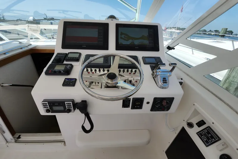 Slide: The Image of Helm of 2009 Cabo 36 Express boat with dual screens and navigation controls. - 7
