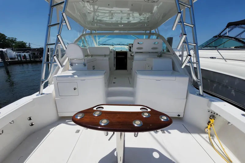 Slide: The Image of 2009 Cabo 36 Express boat interior with seating and fishing rod holders. - 12