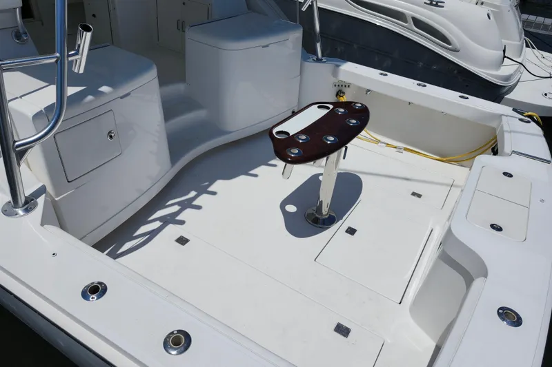 Slide: The Image of 2009 Cabo 36 Express boat deck with fishing rod holders and storage compartments. - 14