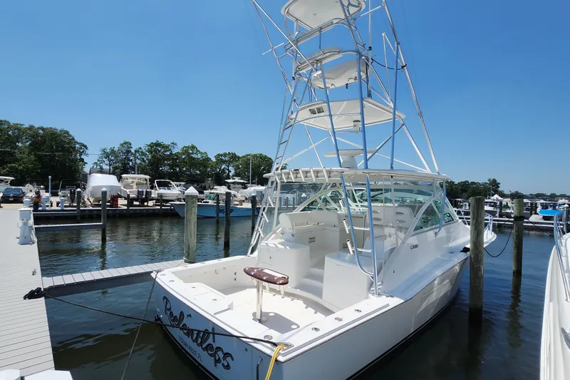 Slide: The Image of 2009 Cabo 36 Express boat docked at marina under clear blue sky. - 4