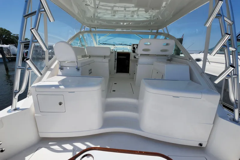 Slide: The Image of 2009 Cabo 36 Express boat interior with seating and helm, docked at marina. - 15