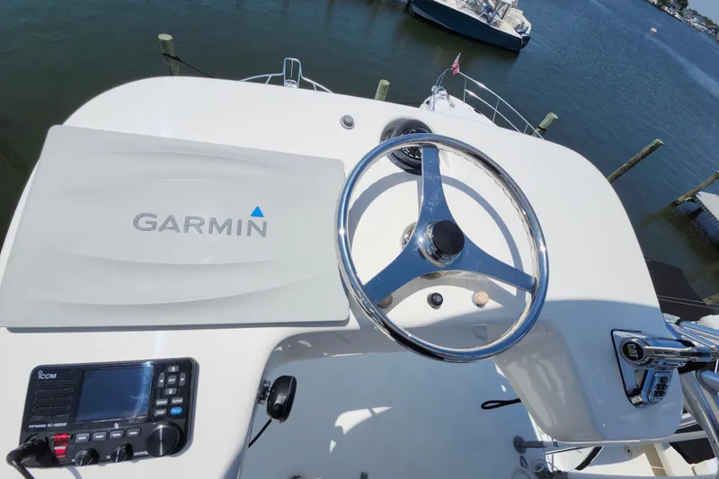 Slide: The Image of Helm of 2009 Cabo 36 Express with Garmin navigation and steering wheel. - 19