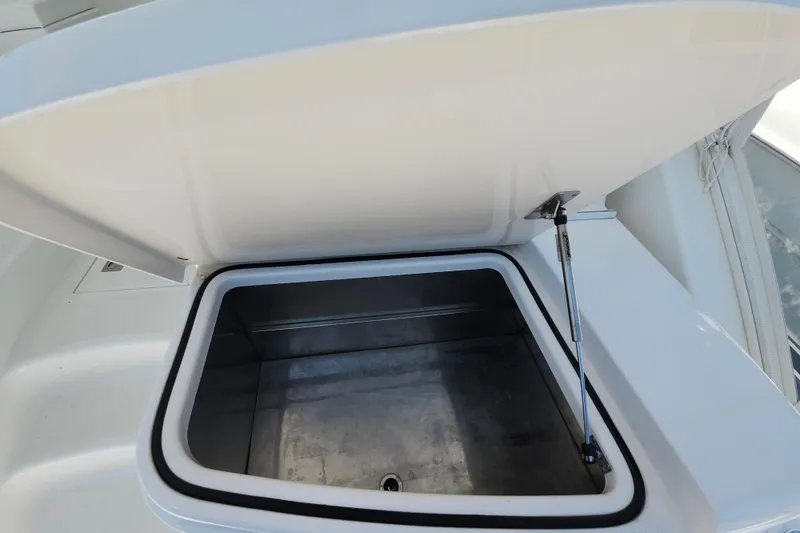 Slide: The Image of Open storage compartment on a 2009 Cabo 36 Express boat. - 23