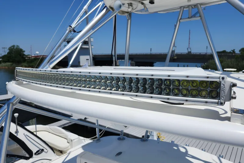 Slide: The Image of 2009 Cabo 36 Express boat with mounted LED light bar, docked near a bridge. - 27