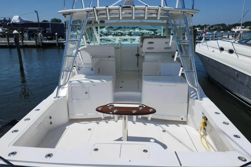 Slide: The Image of 2009 Cabo 36 Express boat with spacious deck and fishing amenities at marina. - 5