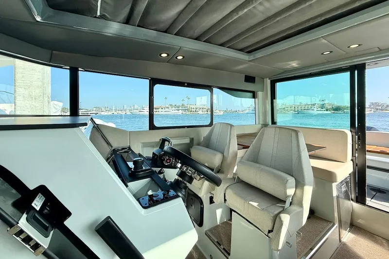 Slide: The Image of Interior of 2024 Saxdor 320 GTC boat with modern helm and seating. - 19