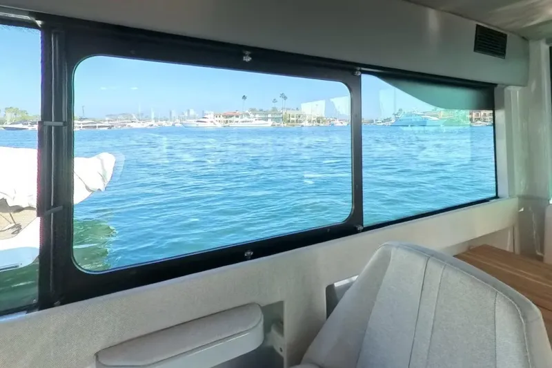Slide: The Image of Interior view from 2024 Saxdor 320 GTC, showcasing marina through large window. - 30