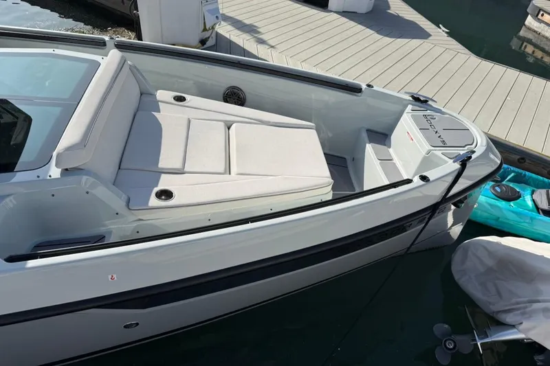 Slide: The Image of 2024 Saxdor 320 GTC boat docked, featuring sleek design and comfortable seating. - 15