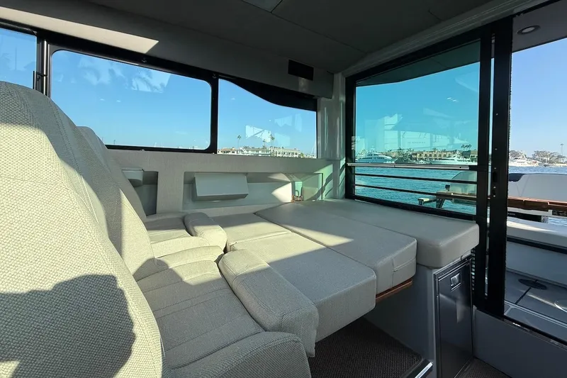 Slide: The Image of Interior of 2024 Saxdor 320 GTC boat with comfortable seating and waterfront view. - 22