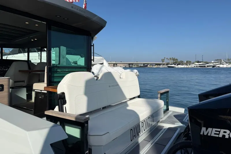 Slide: The Image of 2024 Saxdor 320 GTC yacht docked at Dana Point, featuring sleek design and luxurious seating. - 8
