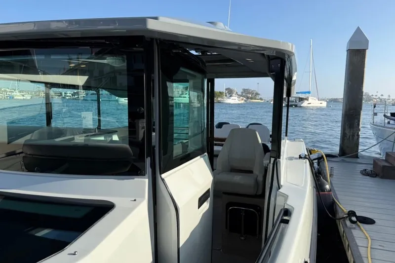 Slide: The Image of 2024 Saxdor 320 GTC boat docked, showcasing sleek design and modern features. - 49