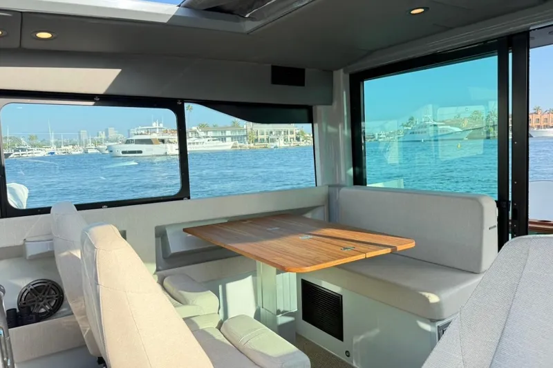 Slide: The Image of Interior of 2024 Saxdor 320 GTC yacht with waterfront view and seating area. - 17
