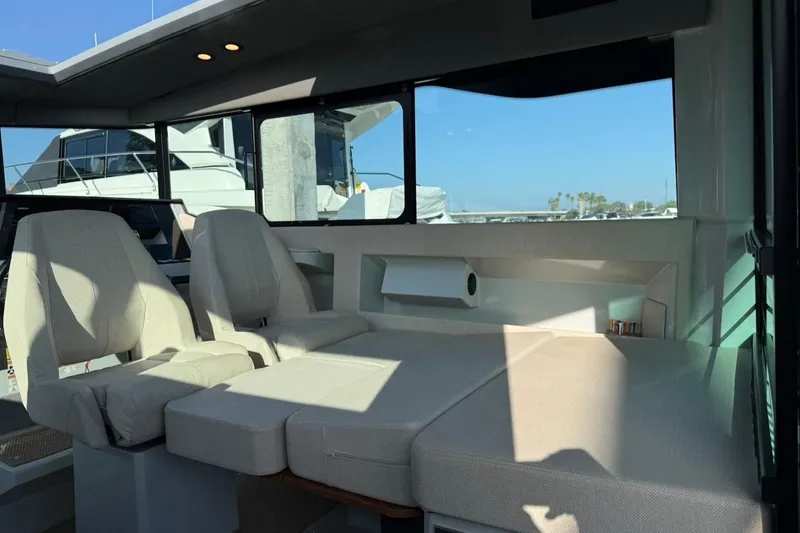 Slide: The Image of Interior of 2024 Saxdor 320 GTC boat with beige seating and large windows. - 21
