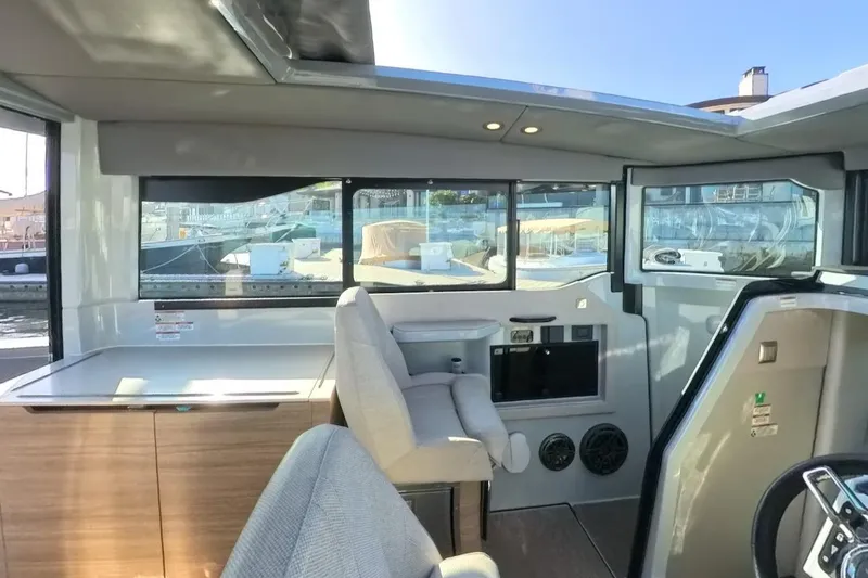 Slide: The Image of Interior of 2024 Saxdor 320 GTC boat, featuring modern seating and large windows. - 18