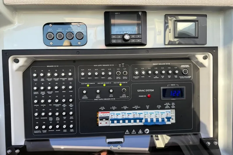 Slide: The Image of Control panel of 2024 Saxdor 320 GTC boat, featuring various switches and displays. - 44