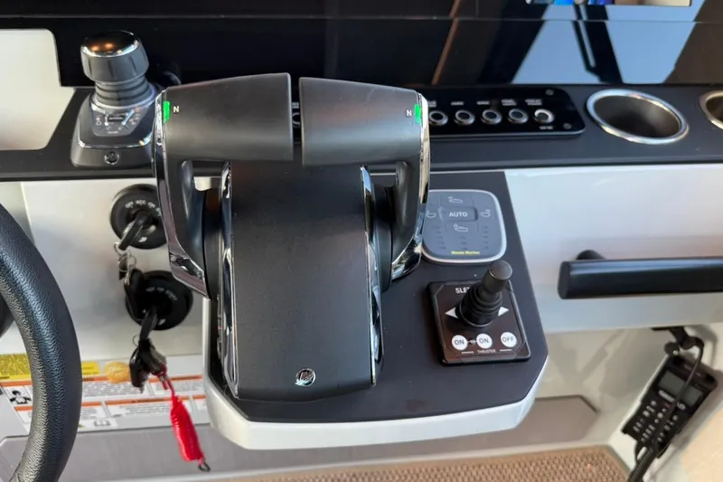Slide: The Image of Control panel of 2024 Saxdor 320 GTC boat with throttle and joystick controls. - 29