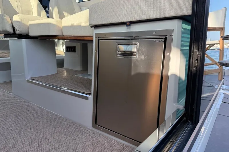 Slide: The Image of 2024 Saxdor 320 GTC interior with seating and built-in stainless steel fridge. - 33
