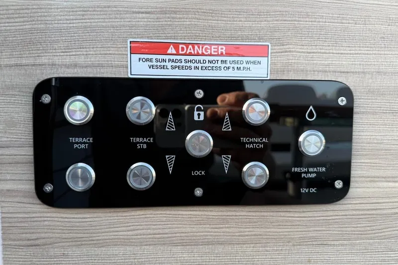 Slide: The Image of Control panel on 2024 Saxdor 320 GTC boat with warning label and various buttons. - 34