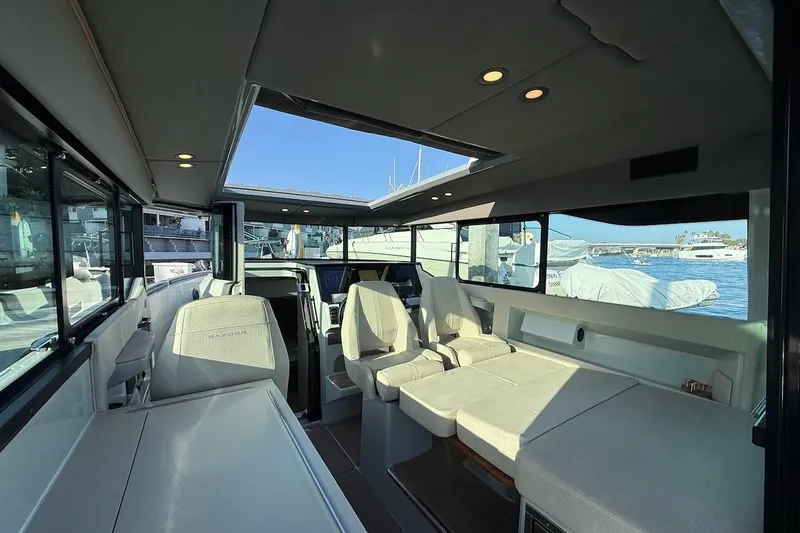 Slide: The Image of Interior of 2024 Saxdor 320 GTC boat, featuring modern seating and panoramic windows. - 20