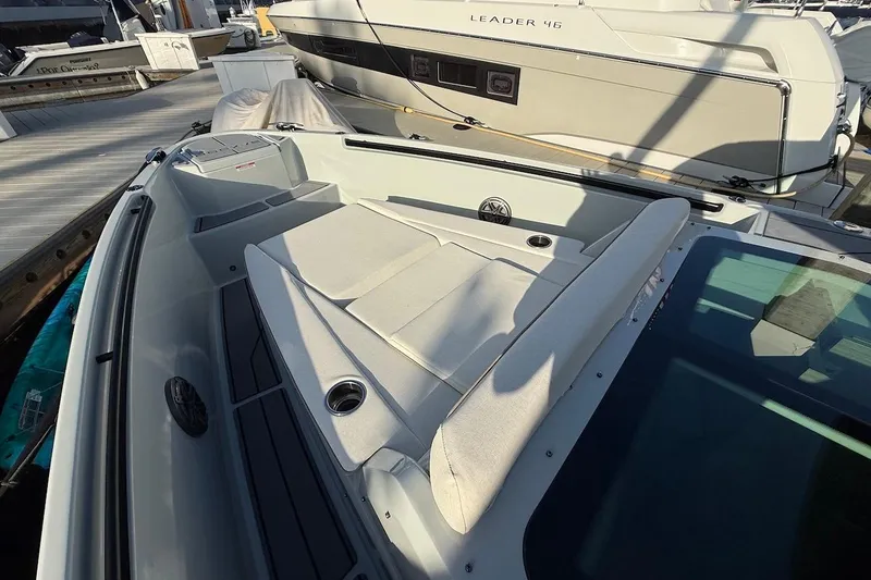 Slide: The Image of 2024 Saxdor 320 GTC boat with spacious deck and comfortable seating at a marina. - 46