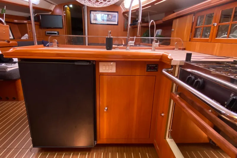 Slide: The Image of Interior of 2005 Hunter 38 sailboat kitchen with wood cabinetry and modern appliances. - 20