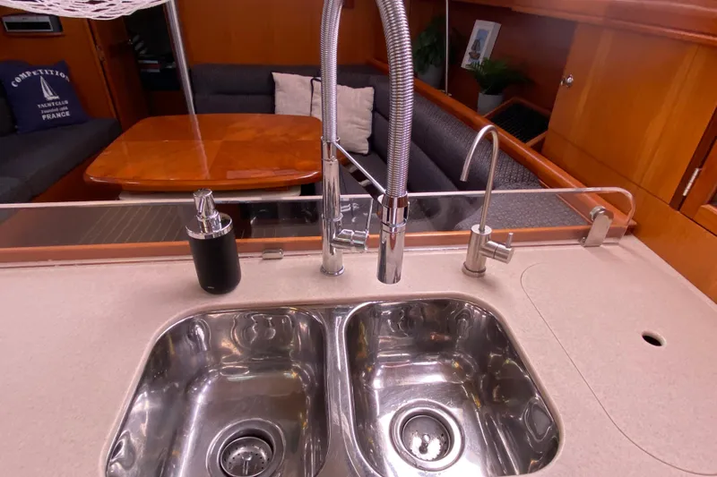 Slide: The Image of Luxurious 2005 Hunter 38 yacht interior with modern kitchen sink and cozy seating area. - 19