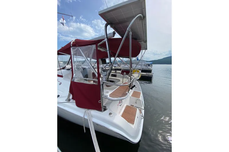 Slide: The Image of Hunter 38 sailboat, 2005 model, docked with red canopy and solar panel. - 10