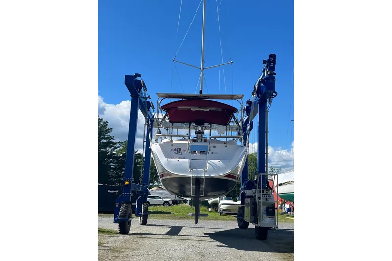 Slide: The Image of Hunter 38 sailboat from 2005 being lifted by a boat hoist. - 30