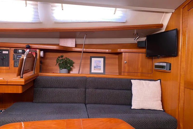 Slide: The Image of Interior of 2005 Hunter 38 sailboat with cozy seating, wooden finish, and modern amenities. - 23