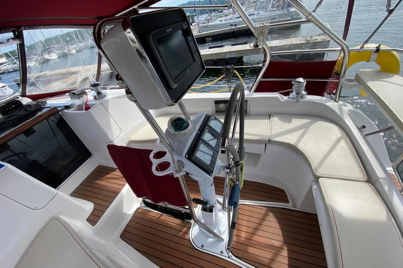 Slide: The Image of Cockpit of 2005 Hunter 38 sailboat with navigation equipment and seating. - 5