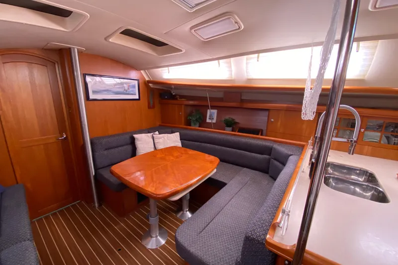 Slide: The Image of Interior of 2005 Hunter 38 sailboat with cozy dining area and modern kitchen. - 21