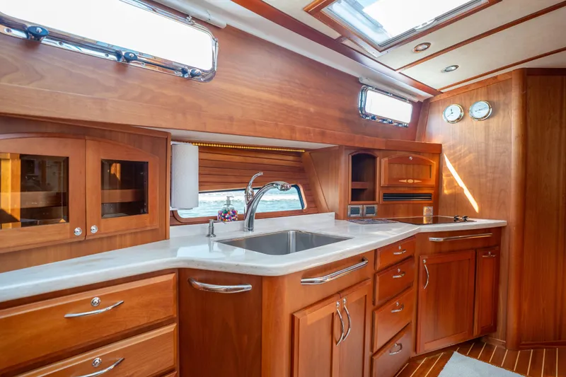 Slide: The Image of Luxurious 2016 Sabre 48 Salon Express yacht interior with elegant wooden cabinetry and modern kitchen amenities. - 29