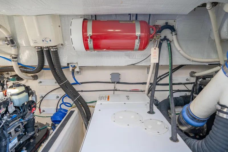 Slide: The Image of Engine room of 2016 Sabre 48 Salon Express with fire extinguisher and various cables. - 50