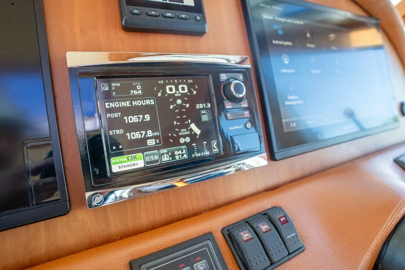 Slide: The Image of Dashboard of a 2016 Sabre 48 Salon Express showing engine hours and controls. - 26
