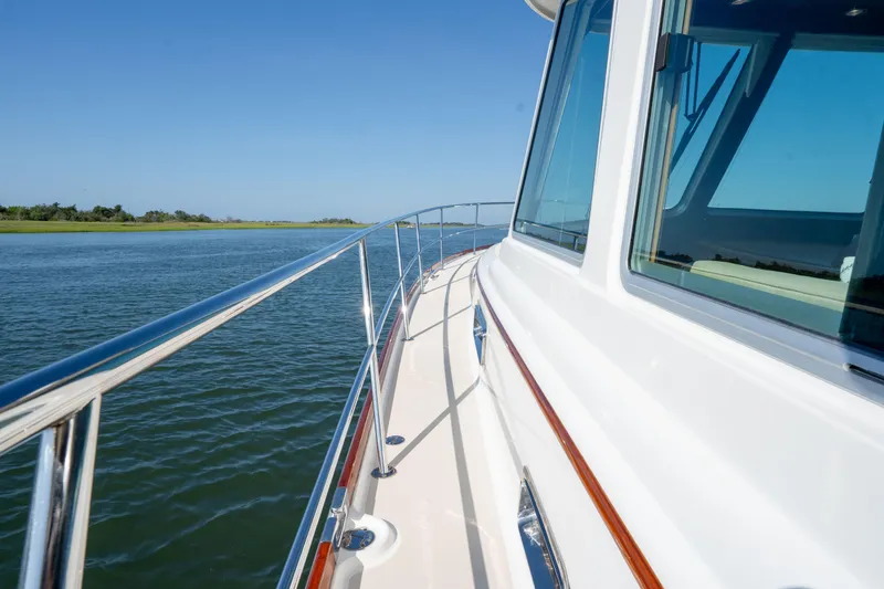 Slide: The Image of 2016 Sabre 48 Salon Express yacht cruising on calm waters under clear blue skies. - 18