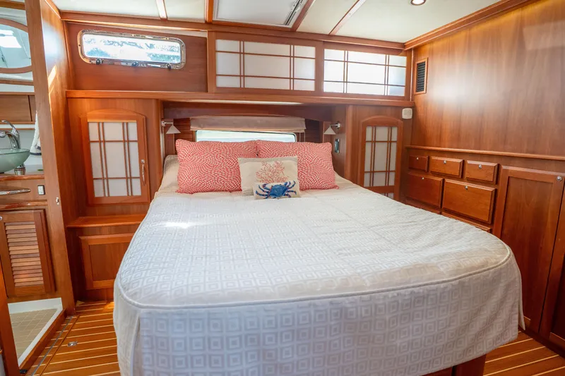 Slide: The Image of Luxurious 2016 Sabre 48 Salon Express cabin with elegant wood interior and cozy bedding. - 31