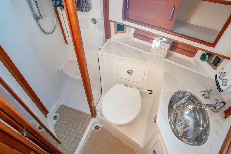 Slide: The Image of Bathroom interior of 2016 Sabre 48 Salon Express yacht, featuring shower, toilet, and sink. - 39