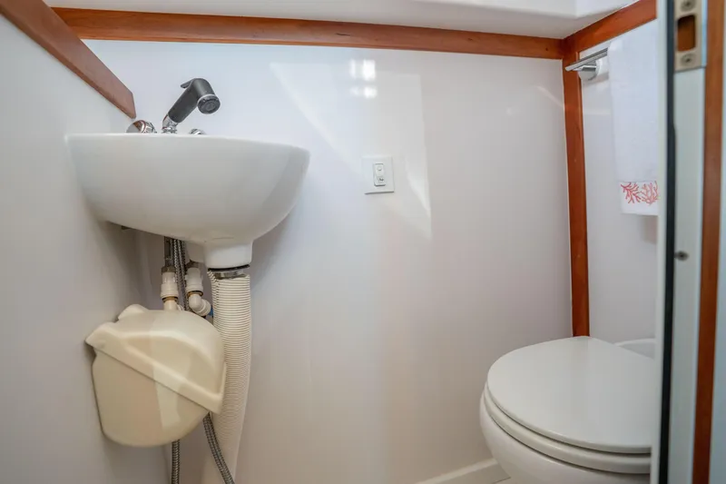 Slide: The Image of Compact bathroom in 2016 Sabre 48 Salon Express yacht with sink and toilet. - 45
