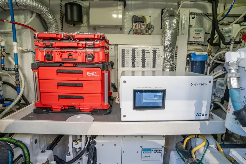 Slide: The Image of Engine room of 2016 Sabre 48 Salon Express with red toolboxes and Spot Zero system. - 49