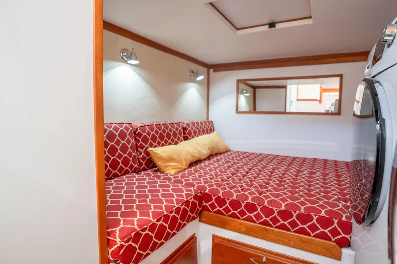 Slide: The Image of Interior cabin of 2016 Sabre 48 Salon Express with red patterned bedding and modern lighting. - 42