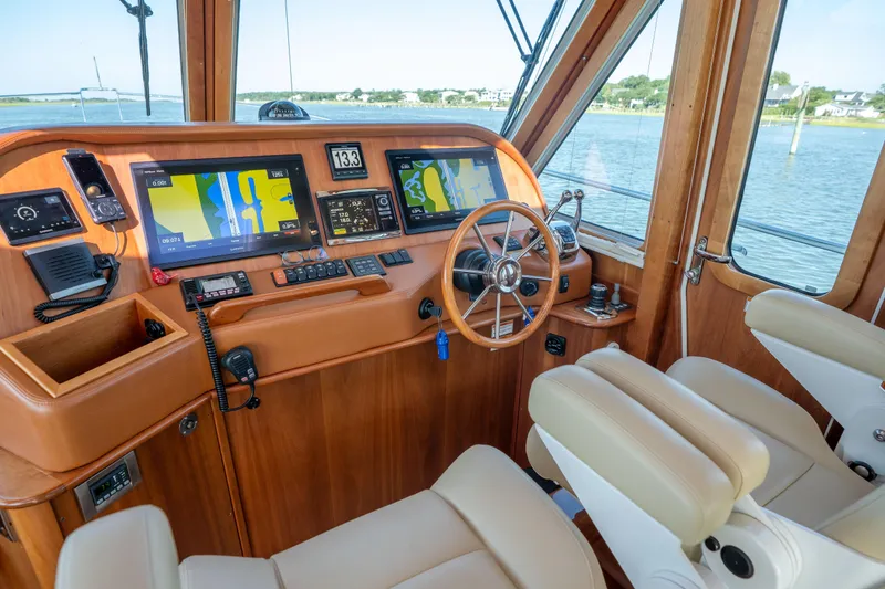 Slide: The Image of Helm of 2016 Sabre 48 Salon Express yacht with navigation screens and steering wheel. - 23